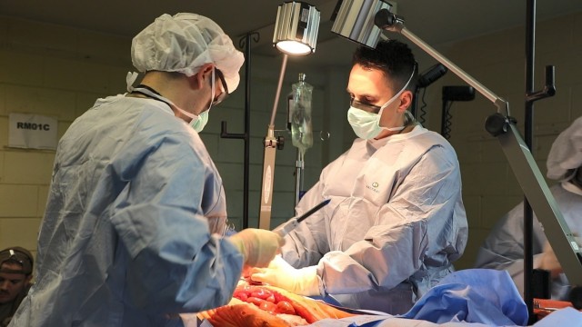 Maj. Alexander Friedman (left), General Surgeon, and Capt. Mitchell Harris (right), Orthopedic Surgeon, assigned to 135th FRST perform damage control surgeries utilizing tissue models.