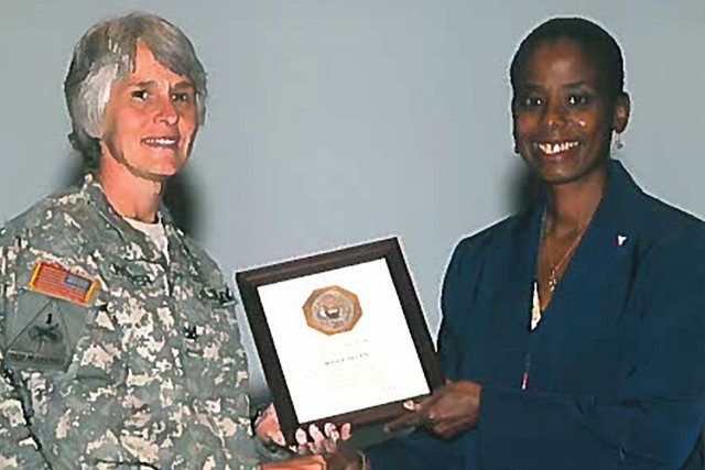 Joyce Allen (Right), Secretary of the General Staff Tank-automotive and Armaments Command, receives a 20 year Length of Service Certificate in 2011 from Col. Jan Hooper (Left), then Chief of Staff TACOM. 
