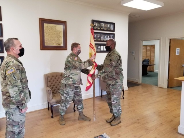 Command Sgt. Maj. Joseph E. Reilly (Left) stands relieved as Lt. Col. Andrew P. Aswell passes Command Sgt. Maj. Renard R. Chaffin the flag during the change of responsibility of U.S. Army Garrison Fort A.P. Hill on December 3, 2020.