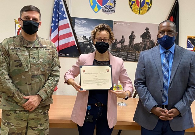 The 405th Army Field Support Brigade commander, Col. Brad Bane, presents the Logistics Readiness Center Rheinland-Pfalz Employee of the Year for 2020 award to Marsha Kaiser, a property book officer and acting LRC Rheinland-Pfalz administrative...