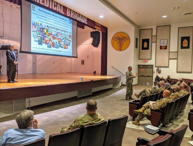Maj. Gen. Daniel R. Walrath, right, commanding general, U.S. Army South, provides remarks during the Reintegration Working Group mission readiness brief at Evans Auditorium Dec. 3. U.S. Army South hosted the annual Personnel Recovery Reintegration...