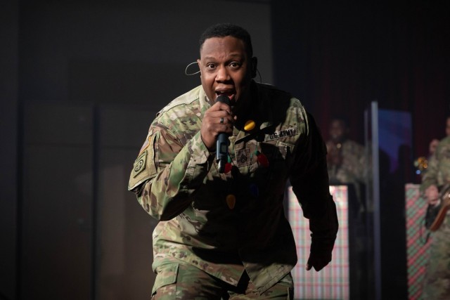 Staff Sgt. Lewis Johnson, lead vocalist for the U.S. Army Training and Doctrine Command Band holiday show, rocks out on their virtual stage. (U.S. Army photo by Staff Sgt. Osvaldo Corea)