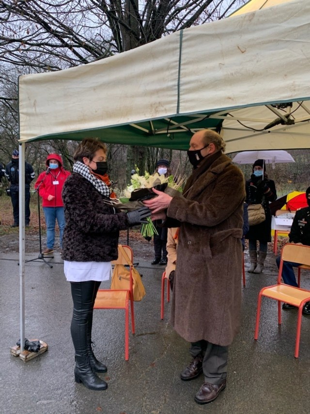 BASTOGNE, Belgium -- U.S. Ambassador to Belgium Ronald Gidwitz, right, gives flowers to Cindy Cobraiville, a nurse who was standing in for all Belgian nurses working during the pandemic, Dec. 11. During a year defined by a global pandemic, a...