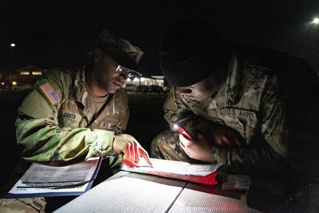 1st Lt. Nickoles Smith, the company executive officer for Headquarters and Headquarters Company, 83rd Chemical, Biological, Radiological, and Nuclear Battalion on Fort Stewart Georgia, grades Cpl. Kevin Thomas, a human resources specialist also...
