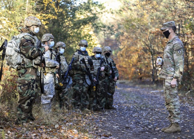 U.S. Army Command Sgt. Maj. Robert Abernathy (right), command sergeant major, U.S. Army Europe and Africa, discusses Operation Courageous Ascent, a training exercise designed to test medical operations in austere environments, with Soldiers participating in the exercise, Nov. 18. The exercise tested medical personnel on a variety of combat medical skills such as applying combat action tourniquets, casualty evacuation, dismounted patrolling, land navigation, movement under fire, communications protocol, identifying and reacting to improvised explosive devices and chemical, biological, radioactive and nuclear attacks.