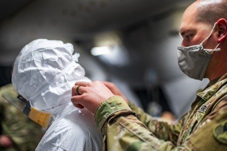 Army Maj. David Alford, a critical care nurse assigned to the 396th Combat Support Hospital, Joint Task Force Bravo, receives assistance putting on a medical protective suit during COVID-19 battle drill rehearsals at Soto Cano Air Base, Honduras,...