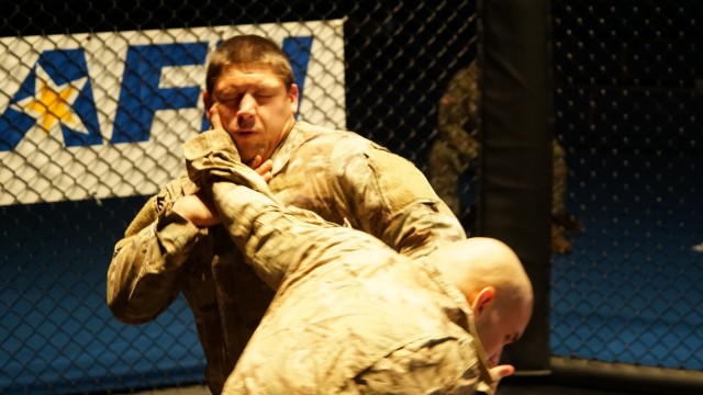 U.S. Army Sgt. Javier Figueroa (right) slaps Sgt. Zachary Morro (right), assigned to the 3rd Squadron, 2d Cavalry Regiment, during the 2CR Fight Night Round Two event at the Memorial Gym, Rose Barracks, Germany, Dec. 11, 2020. 2CR Fight Night is an annual modern Army combatives program event that enables Soldiers to challenge each other - head-to-head - at a chance to win trophies and receive recognition among their peers. (U.S. Army photo by Staff Sgt. William Rawlins)