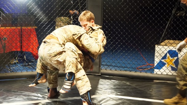 U.S. Army Sgt. Ivan Reyes (left), assigned to the 3rd Squadron, 2d Cavalry Regiment, and Spc. Everett Chapman (right), assigned to the Regimental Support Squadron, 2CR, compete in the light weight bracket during the 2CR Fight Night Round Two event at the Memorial Gym, Rose Barracks, Germany, Dec. 11, 2020. 2CR Fight Night is an annual modern Army combatives program event that enables Soldiers to challenge each other - head-to-head - at a chance to win trophies and receive recognition among their peers. (U.S. Army photo by Staff Sgt. William Rawlins)