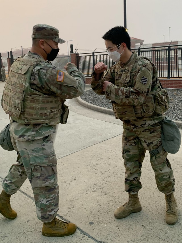 Sgt. Kalito Lasenby, 2nd Battalion, 7th Infantry Regiment, 1st Armored Brigade Combat Team, 3rd Infantry Division, welcomes KCpl. Jung Gwang-Min, a Korean Augmentation to the U.S. Army assigned to 2-7INF, to the Battalion after the 2-7IN KATUSA Patching ceremony, November 16, 2020, at Camp Humphreys, Republic of Korea.  U.S. Soldiers and KATUSAs first executed a circuit of exercises while wearing their body armor and M50 Joint Service General Purpose Mask, then held a ceremony to switch the KATUSAs’ former unit patch with the 3ID patch.  This ceremony formally welcomed the KATUSAs into the Cottonbaler battalion and promoted unity between the Soldiers. (U.S. Army photo by 1st Lt. Hope McCraw)