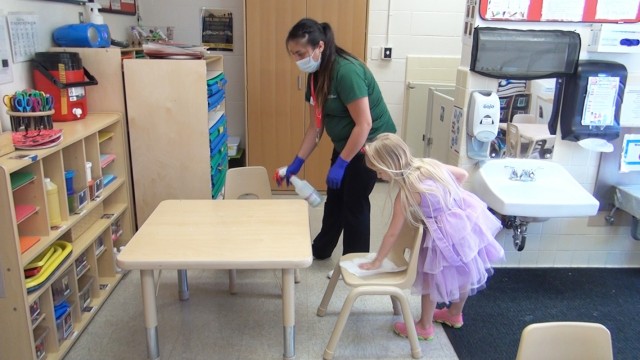A Fort Hunter Liggett Child and Youth Services employee and her "helper" sanitize the furniture during the COVID-19 pandemic. Despite the challenges, Fort Hunter Liggett's CYS achieved a perfect score during the December 2020 Army Higher Headquarters Inspection.