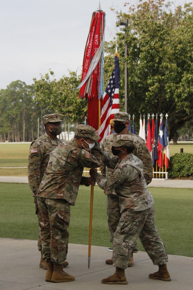 Command Sgt. Maj. Paulette Abraham, right, passes the battalion colors to Lt. Col. Kelly McCay, Headquarters and Headquarters Battalion commander,  3rd Infantry Division, during a change of responsibility ceremony at Marne Garden on Fort Stewart, Georgia, Oct. 23, 2020. Following more than 30 years of service, Abraham is retiring to El Paso, Texas, with her husband, where she said they will enjoy spending time on their favorite hobbies which include golf, hiking and woodworking. (U.S. Army photo by Pfc. Aaliyah Craven, 50th Public Affairs Detachment)