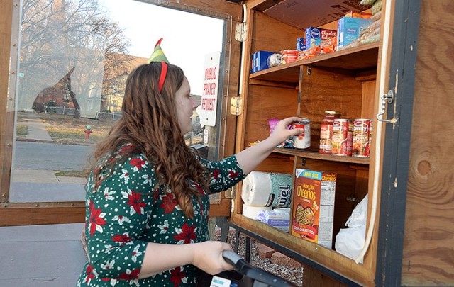 Bradley Elementary School fourth-grade teacher Ally Jackson sorts and restocks the Faith Evangelistic Center Blessing Box with items such as cereal, pop-top soups, granola bars and toiletries donated by the staff at Bradley Dec. 9 in Leavenworth....
