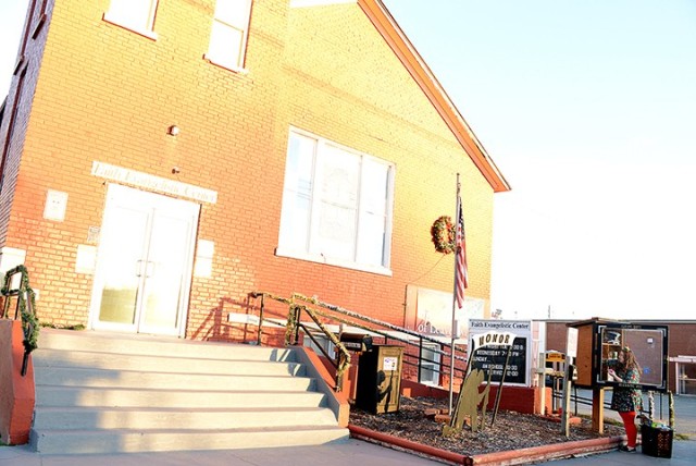 In front of the Faith Evangelistic Center at 120 N. Broadway in Leavenworth, Bradley Elementary School fourth-grade teacher Ally Jackson sorts and restocks the church's blessing box with items such as cereal, pop-top soups, granola bars and...