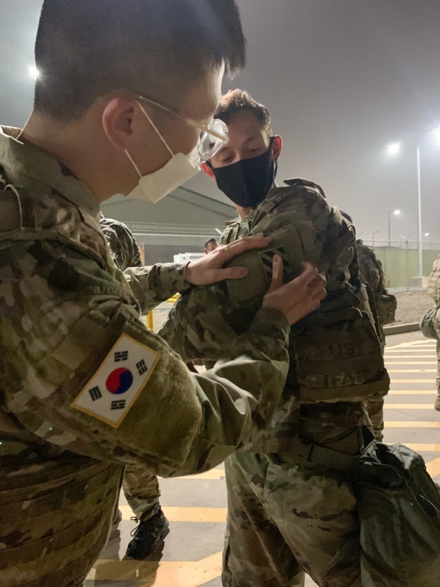 KCpl. Kil Tae Seung, a Korean Augmentation to the U.S. Army assigned to the 2nd Battalion, 7th Infantry Regiment, 1st Armored Brigade Combat Team, 3rd Infantry Division, places a new 3ID patch on Spc. Hunter Moore, a Soldier assigned to 2-7INF, during the 2-7IN KATUSA Patching ceremony, November 16, 2020, at Camp Humphreys, Republic of Korea.  U.S. Soldiers and KATUSAs first executed a circuit of exercises while wearing their body armor and M50 Joint Service General Purpose Mask, then held a ceremony to switch the KATUSAs’ former unit patch with the 3ID patch.  This ceremony formally welcomed the KATUSAs into the Cottonbaler battalion and promoted unity between the Soldiers. (U.S. Army photo by 1st Lt. Hope McCraw)