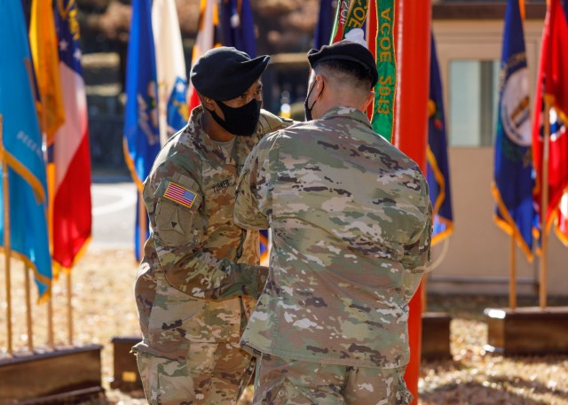 Col. Thomas Matelski, right, commander of U.S. Army Garrison Japan, hands the colors to Command Sgt. Maj. Justin E. Turner, the garrison’s incoming command sergeant major, during an assumption of responsibility ceremony at Camp Zama, Japan, Dec. 17.