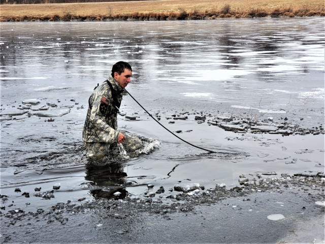 A Fort McCoy Cold-Weather Operations Course (CWOC) Class 21-01 student participates in cold-water immersion training Dec. 15, 2020, at Big Sandy Lake on South Post at Fort McCoy, Wis. CWOC students are trained on a variety of cold-weather...