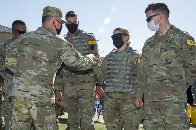 Gen. Paul Funk II, U.S. Army Training and Doctrine Commander presents the winning team of the Best Advanced Individual Training (AIT) Medic Competition a commander’s coin for excellence at Joint Base San Antonio-Fort Sam Houston, Texas on...