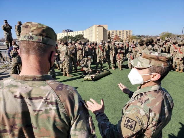(Right) Lt. Col. Manuel Menendez, 232d Medical Battalion Commander, briefs (left) Gen. Paul Funk II, U.S. Army Training and Doctrine Commander on the Battalion’s Best Advanced Individual Training (AIT) Medic Competition at Joint Base San...