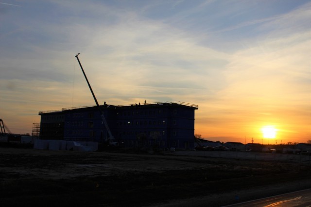An area of the 1600 block of the cantonment area of the installation is shown Dec. 10, 2020, at sunset as a new multi-million dollar barracks is being built at Fort McCoy, Wis. Contractor L.S. Black Constructors was awarded a $20.6 million contract to build the barracks in September 2019. The planned completion date is currently August 2021. The planned barracks will be different than the traditional barracks that are located throughout the installation. This new building is four stories and be able to house 400 people in approximately 60,000 square feet. The project also is the first of eight new buildings planned for the entire 1600 block at Fort McCoy. The plan is to build three more barracks with the same specifications, three 20,000-square-foot brigade headquarters buildings, and one 160-room officer quarters. This is an Army Corps of Engineers-managed project. (U.S. Army Photo by Scott T. Sturkol, Public Affairs Office, Fort McCoy, Wis.)