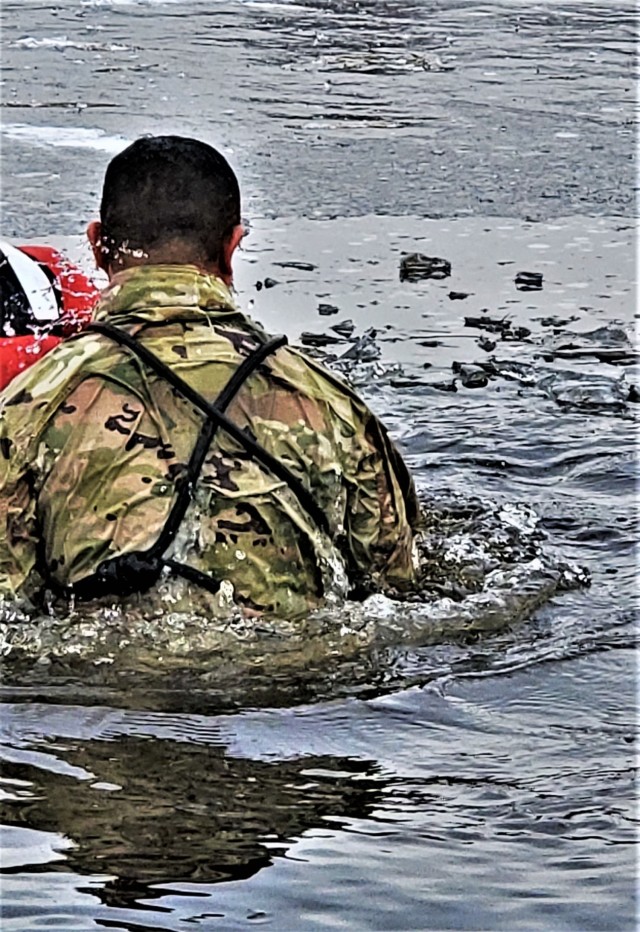 A Fort McCoy Cold-Weather Operations Course (CWOC) Class 21-01 student participates in cold-water immersion training Dec. 15, 2020, at Big Sandy Lake on South Post at Fort McCoy, Wis. CWOC students are trained on a variety of cold-weather...