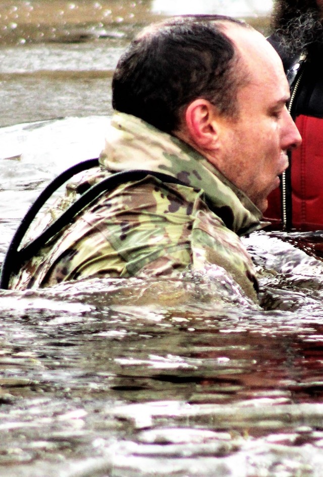 A Fort McCoy Cold-Weather Operations Course (CWOC) Class 21-01 student participates in cold-water immersion training Dec. 15, 2020, at Big Sandy Lake on South Post at Fort McCoy, Wis. CWOC students are trained on a variety of cold-weather...