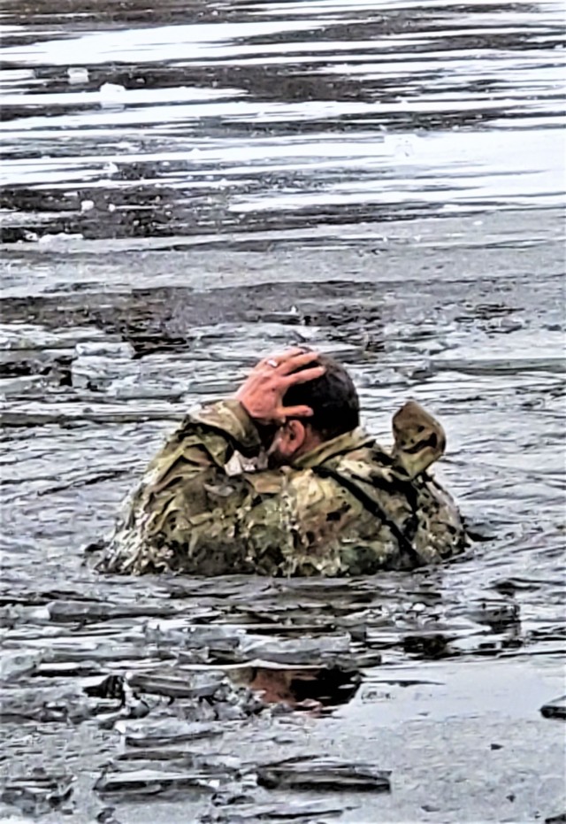 A Fort McCoy Cold-Weather Operations Course (CWOC) Class 21-01 student participates in cold-water immersion training Dec. 15, 2020, at Big Sandy Lake on South Post at Fort McCoy, Wis. CWOC students are trained on a variety of cold-weather...