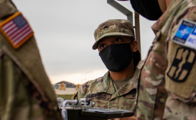 U.S. Army Sgt. Jaquaila Bradford, a Soldier assigned to the 566th Medical Company (Area Support) based in Fort Hood, Texas, listens to a demonstration on the use of a wet bulb globe temperature index calculator during a field sanitation class at...