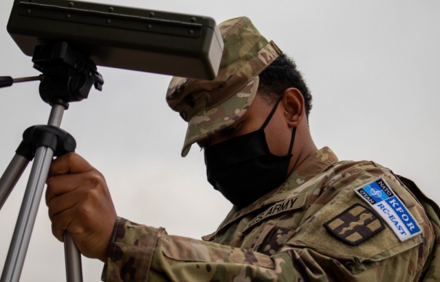 U.S. Army Spc. Trent Tardy, a Soldier assigned to the 566th Medical Company (Area Support) based in Fort Hood, Texas, sets up a wet bulb globe temperature index calculator during a field sanitation class at Camp Bondsteel, Kosovo, on Dec. 17,...