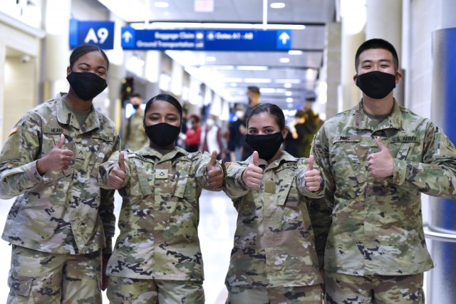 U.S. Army Medical Center of Excellence Soldiers headed to Holiday Block Leave from the San Antonio International Airport demonstrate their enthusiasm for the well-deserved break on December 19, 2020.