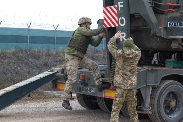 Members of the Ukrainian Freedom of Maneuver Detachment unload a BAT-2 armored tracklayer during obstacle and barrier removal training at Camp Marechal de Lattre De Tassigny in Kosovo on Dec. 16, 2020. The BAT-2 armored tracklayer is capable of clearing any routes that may be blocked threatening freedom of movement. The FOMD cooperated with U.S. forces to complete the training exercise, and has trained many multinational units in support of NATO’s Kosovo Force. KFOR is dedicated to maintaining peace and stability in the region through regular training and joint cooperation. (U.S. Army National Guard photo by Sgt. Zachary M. Zippe)