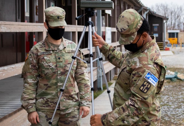 U.S. Army Spc. Jacob Crowson and Spc. Trent Tardy, Soldiers assigned to the 566th Medical Company (Area Support) based in Fort Hood, Texas, set up a wet bulb globe temperature index calculator during a field sanitation class at Camp Bondsteel,...