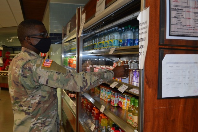 Spec. Jean-Rene Louis, a nutrition case specialist in the Department of Nutrition chooses a beverage to go with his meal in the Brooke Army Medical Center dining facility, Dec. 8, 2020. Staff at BAMC’s Nutrition Department encourage everyone to...