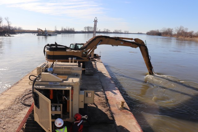 A Kansas City District track-hoe on a barge work boat took part in hydrodynamic dredging operations on the Missouri River November 11, 2020. The hydrodynamic dredge head is mounted on the bucket and the arm directs the flow the desired area of...