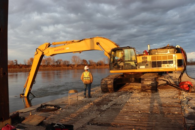 A Kansas City District track-hoe on a barge work boat took part in hydrodynamic dredging operations on the Missouri River November 11, 2020. The hydrodynamic dredge head is mounted on the bucket and the arm directs the flow the desired area of...