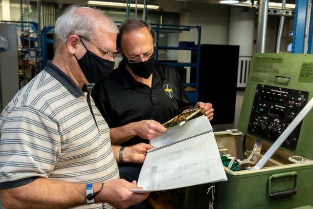In-Circuit Test (ICT) and Functional Verification Test (FVT) capabilities were developed/implemented to support Volcano circuit card assembly (CCA) repair and fabrication efforts. Pictured: Mark Sgobba and Bill Rumble troubleshoot/fault isolate...