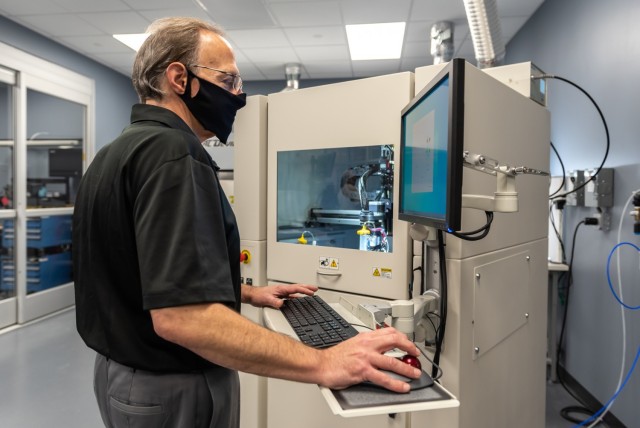 Mark Sgobba, electronics engineer, develops a program for the selective conformal coating/curing system. UV-curable conformal coating is automatically applied to each CCA in liquid or gel form avoiding various keep-out regions like card guides,...
