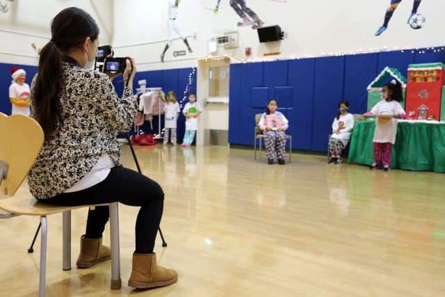 Michelle Baldwin-Trotter, director of the School Age Center, films the center’s holiday play for parents at Sagamihara Family Housing Area, Japan, Dec. 18.