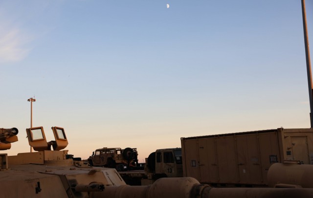 CONSTANTA, Romania – The moon rises over vehicles waiting to be loaded onto a nearby ship at the beginning of what would be a long night of work for Soldiers and their civilian partners. 80 Soldiers from 3rd Battalion, 15th Infantry Regiment out of Fort Stewart, Ga. loaded 260 vehicles and shipping containers in 12 hours here on Nov. 23 in what was the final step of a month-long process of the redeployment of equipment and troops back to their home station. (U.S. Army Photo by Sgt. H. Marcus McGill)