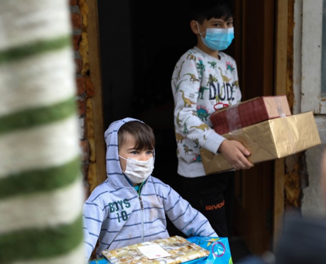 BUCHAREST, Romania – Two brothers walk outside with the Christmas presents they just received on Dec. 21. Through the combined efforts of Civil Affairs Team 3231, 432nd Civil Affairs Battalion, Green Bay, Wis., Office of Defense Cooperation,...