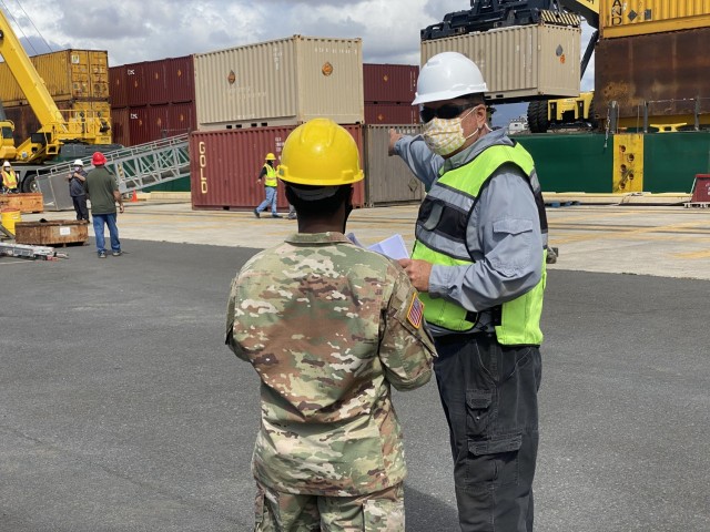 402nd AFSB Accountable Officer Ted Mchugh instructs the borrowed military man power on how to direct the movement of the containers off the vessel for staging. Once a container is moved to the staging area, it is then ready to be transported to Lualualei Annex, where it will be emptied and the contents stored.