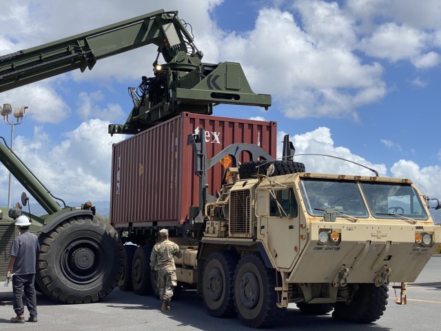 Once containers are moved off the vessel, they are loaded on to Army trucks for transport to Lualualei Annex.