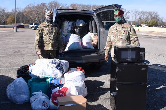 U.S. Army Space and Missile Defense Command’s Sgt. 1st Class Trenton Huntsinger, noncommissioned officer in charge, G3, left, and Command Sgt. Maj. Finis Dodson, USASMDC command sergeant major, collect items for a local homeless shelter during a...