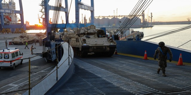 CONSTANTA, Romania – As vehicles line up, a Soldier ground guides a vehicle up the ramp onto the ship. 80 Soldiers from 3rd Battalion, 15th Infantry Regiment out of Fort Stewart, Ga. loaded 260 vehicles and shipping containers in 12 hours here on Nov. 23 in what was the final step of a month-long process of the redeployment of equipment and troops back to their home station. (U.S. Army Photo by Sgt. H. Marcus McGill)