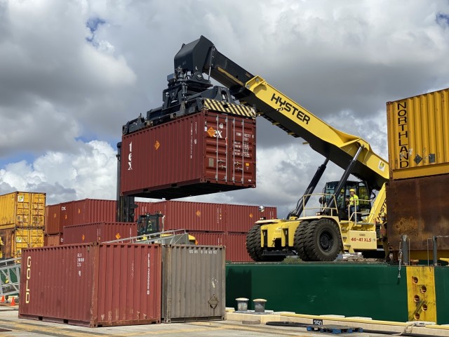 A container full of new ammunition is moved off the vessel.