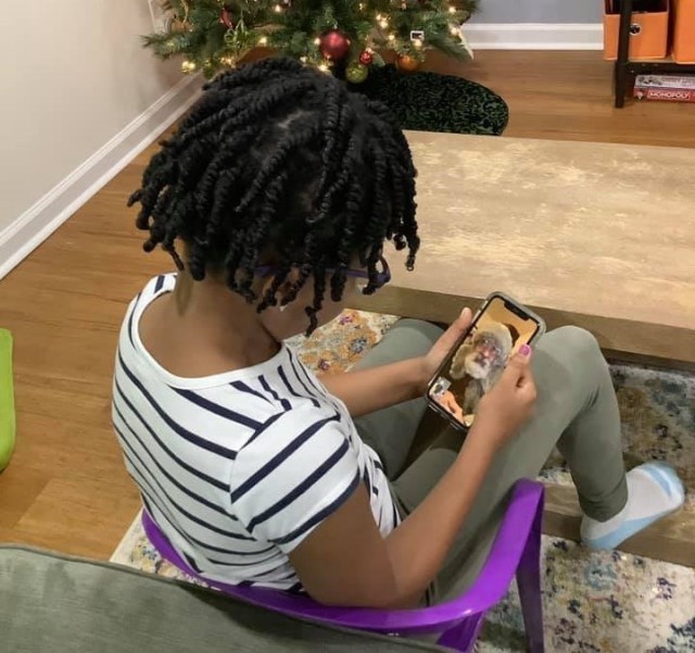 Dressed as &#34;Santa Todd,&#34; Todd Bishop, a U.S. Army Medical Materiel Agency civilian employee, talks with a child via a FaceTime call during a virtual visit. Bishop has found new ways to leverage technology to continue bringing some holiday magic to children despite COVID-19 restrictions.