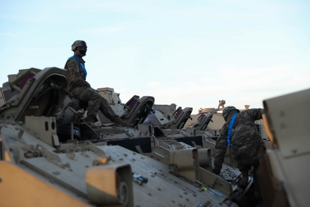 CONSTANTA, Romania – Drivers and ground guides prepare vehicles to be boarded onto a nearby ship. 80 Soldiers from 3rd Battalion, 15th Infantry Regiment out of Fort Stewart, Ga. loaded 260 vehicles and shipping containers in 12 hours here on Nov. 23 in what was the final step of a month-long process of the redeployment of equipment and troops back to their home station. (U.S. Army Photo by Sgt. H. Marcus McGill)