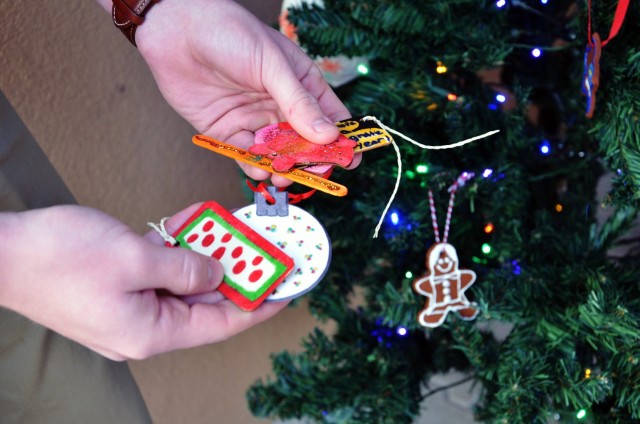 VICENZA, Italy - Casey Dugan, Sergeant Morales Club member, holds some of the one hundred homemade ornaments created by many children in the community to decorate the eight Christmas trees to deliver to Villaggio Army Family Housing. 
...