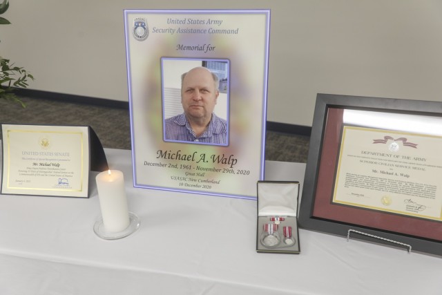 Awards and presentations for the family of Michael Walp, a 32-year employee who died away unexpectedly, Nov 29. Walp was a logistics management specialist and team leader for the Army Security Assistance Command's office in New Cumberland, Pa. (photo by Joel Vazquez)
