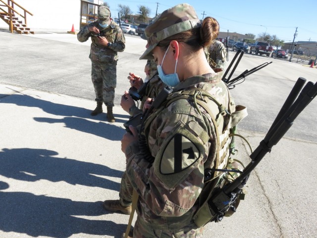 Fort Hood, Texas -SPC Joanna Johnson and 1st CAV Soldiers preparing to enter coordinates into the Hand-Held, Manpack, and Small Form Fit (HMS) system on the Central Technical Support Facility campus.