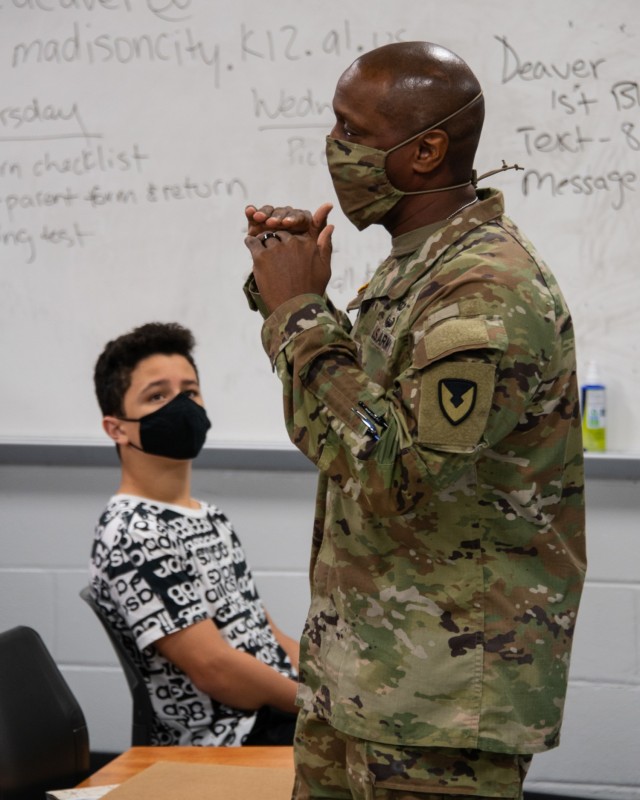 Command Sgt. Maj. Sean Rice, from U.S. Army Security Assistance Command at Redstone Arsenal, speaks to the JROTC class at Bob Jones High School, 12 Nov., in Huntsville, AL. Command Sgt. Maj. Rice amused the students with stories from his time with...